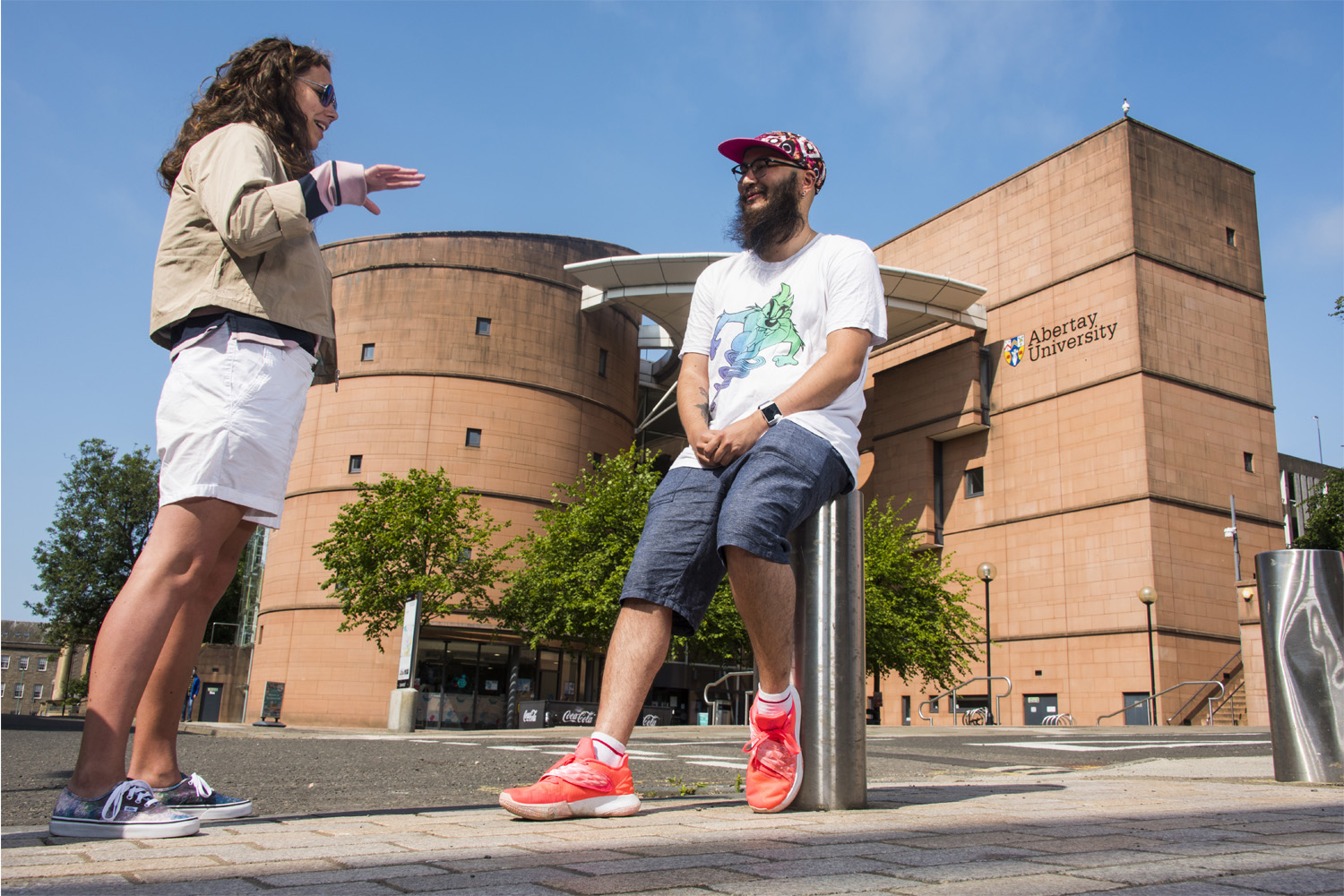 Two students chatting outside the Abertay library