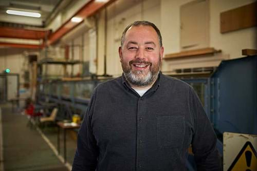 Dr Daniel Gilmour smiling in a lab setting