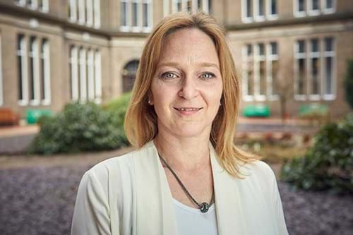 Paula Forbes head shot half-smiling at the camera