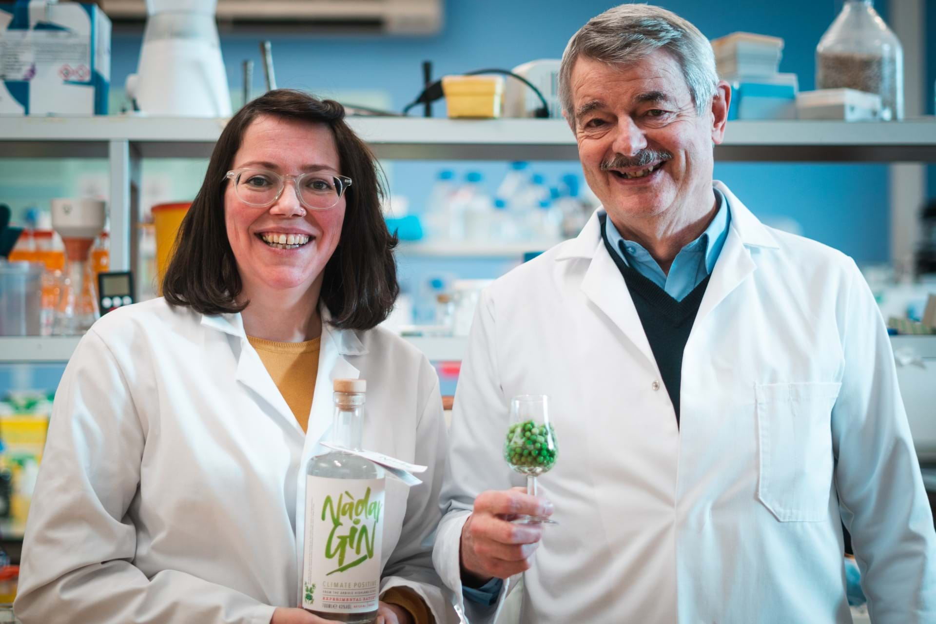 Kirsty Black and Graeme Walker holding a bottle of Nadar Gin and a glass of peas