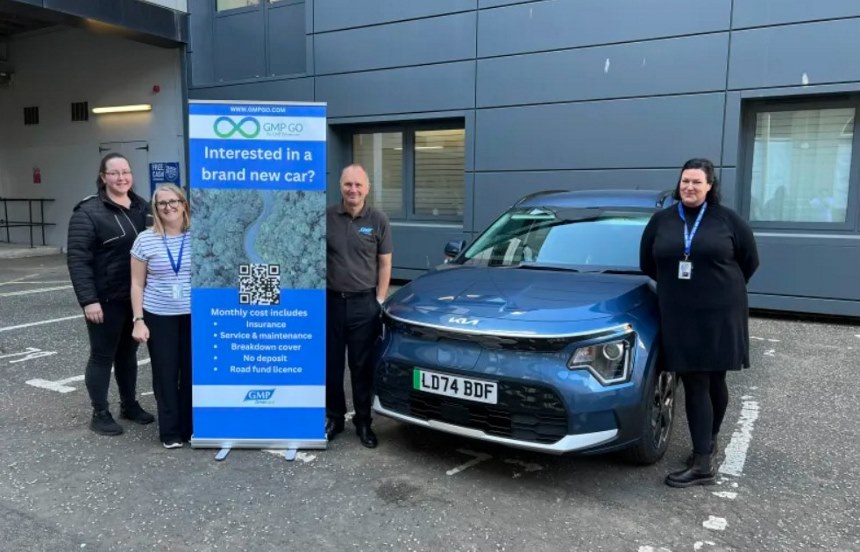 Abertay and GMP Drivercare staff pose with an electric car