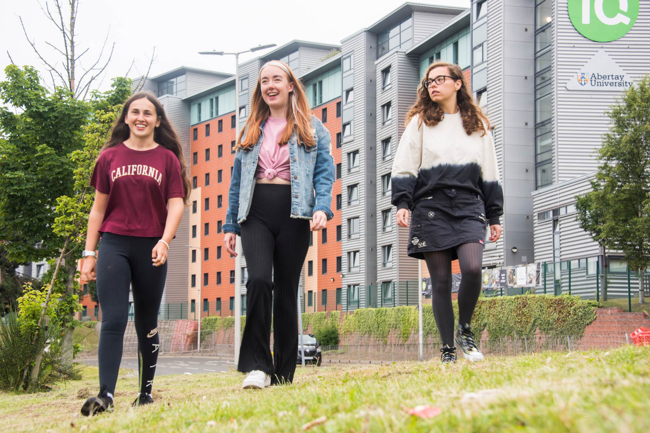 Three students walking outside Parker House